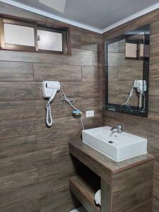 a bathroom with a sink and a mirror at Berni's Deluxe Villa in Tanque
