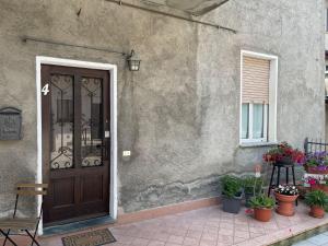 a front door of a house with potted plants at Appartamento 4 del Vecchio Convento in Orino