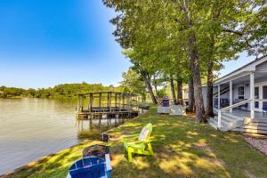 a house with a dock next to a body of water at Waterfront Lake Hamilton Vacation Rental with Dock! in Royal
