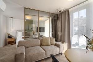 a living room with a couch and a bedroom at Silent Stone Apartment in Vrsar