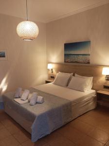 a bedroom with a bed with two pillows on it at Nikolaos Studios Skala in Skala Kefalonias