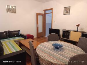 a living room with a bed and a table and chairs at Apartments Salute in Mostar