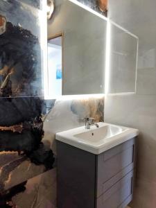a bathroom with a sink and a mirror at Apartments Marija in Vir +9 photos