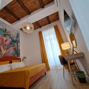 a bedroom with a yellow bed and a window at Domus SIRENA in Naples