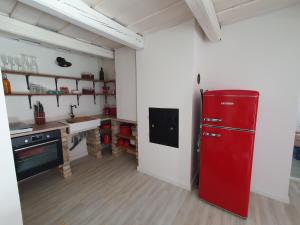 a kitchen with a red refrigerator in a room at GOfoREST - 150y Old Vintage Cottage Balaton - max 6 person in Várvölgy