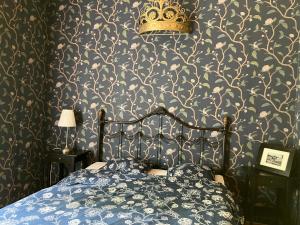 a bedroom with a bed with a crown on the wall at VILLA ANNA in Naantali