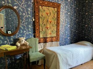 a bedroom with a bed and a table with a mirror at VILLA ANNA in Naantali