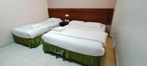 Postel nebo postele na pokoji v ubytování Kampar Times Inn Hotel