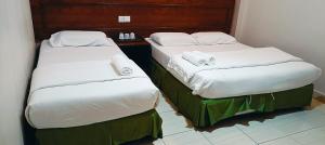 Postel nebo postele na pokoji v ubytování Kampar Times Inn Hotel