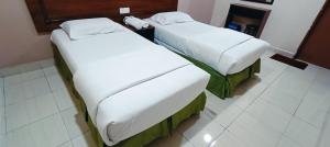 Postel nebo postele na pokoji v ubytování Kampar Times Inn Hotel