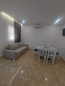 a living room with a couch and a table at Piazza Apartments in Velipojë