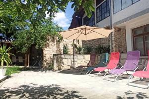 a group of chairs and an umbrella on a patio at Forest house in Varna City