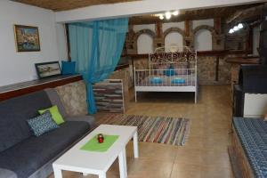 a living room with a couch and a crib at Forest house in Varna City +42 photos
