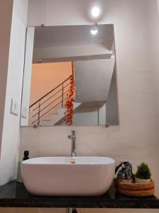 a bathroom with a large mirror and a sink at Mahadev Mansion in Ujjain +27 photos