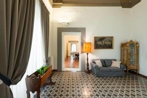 a living room with a couch and a chair at Palazzo D'Ambra Residenza d'Epoca in Florence