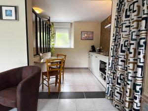 a kitchen and dining room with a table and chairs at CHAMBRES D'HOTES in Loudéac