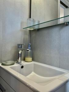a white sink in a bathroom with a mirror at Iris Sunset View Home in Samos