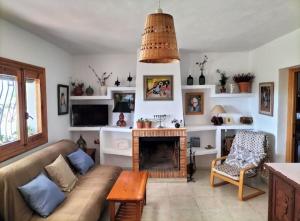 a living room with a couch and a fireplace at Cortijo El Ventorrillo de Agua Amarga in Almería