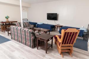 a living room with a couch and a tv at 2 Bed, 1 Bath, Lower Level Loft in New Baltimore