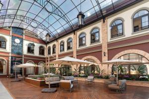 a lobby with chairs and umbrellas in a building at Pousada Luis XV in Campos do Jordão