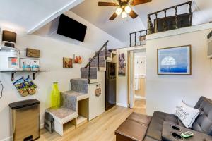 a living room with a staircase and a couch at Pet-Friendly Raleigh Tiny Home with Patio in Raleigh
