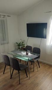 a table and chairs in a room with a television at Apartment Grubelić in Tribunj
