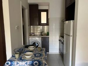 a kitchen with a table with dishes on it at Old town studio in Limassol