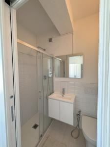 a bathroom with a shower and a sink and a toilet at CYTRUS apartament in Marina di Massa +32 photos