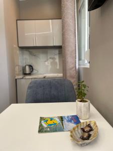 a table with a blue chair and a plate on it at Guest house Luli Strumi in Berat +10 photos