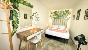 a small bedroom with a bed and a desk at Ancestral Hostel Barranco in Lima +85 photos