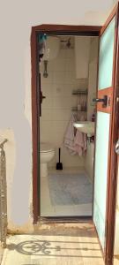 a small bathroom with a toilet and a sink at Charme & Relax in Centro Storico in Gavorrano