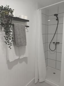 a white bathroom with a shower and a towel at Tropical Nights 2 Apartamento cerca de la playa in Cala Millor