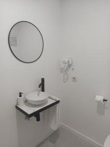 a bathroom with a sink and a mirror on the wall at Tropical Nights 2 Apartamento cerca de la playa in Cala Millor +8 photos