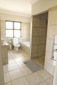 ein Badezimmer mit Badewanne, Toilette und Waschbecken in der Unterkunft Shiloh Cottage in Champagne Valley + 27 Fotos