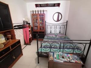 a bedroom with a bed and a dresser and a tv at Appartement agreable sur le bassin d'arcachon in Gujan-Mestras