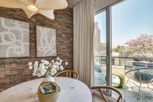 a dining room with a table with a vase of flowers at Rooftop with Views Modern Little Italy Townhome in San Diego