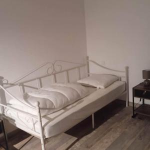 a white bed with pillows on it in a room at Duplex Campagne in Tocane-Saint-Apre