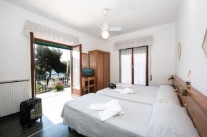 Ένα ή περισσότερα κρεβάτια σε δωμάτιο στο Hotel Tirreno