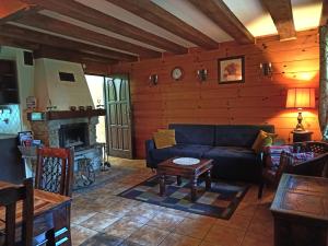 a living room with a couch and a fireplace at Osada Magury - Bieszczady in Wetlina