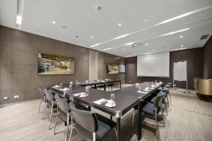 a conference room with a long table and chairs at BOG Hotel in Bogotá +70 photos