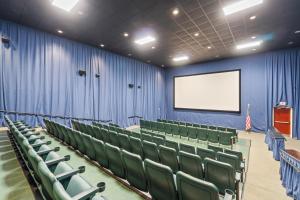 a lecture room with green chairs and a screen at Majestic Beach Resort Tower I by Panhandle Getaways in Panama City Beach