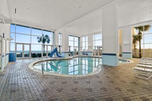 a swimming pool with a slide in a building at Majestic Beach Resort Tower I by Panhandle Getaways in Panama City Beach +8 photos