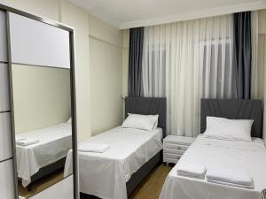 Postel nebo postele na pokoji v ubytování Köseoğlu APART
