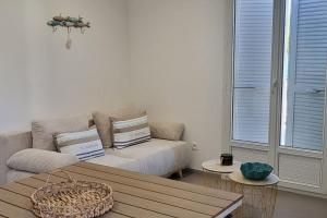 a living room with a couch and a table at Casa Figarella in Calenzana