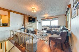 a living room with a couch and a table at Beachfront Anderson Island Escape Rainier Views! in Beachcrest