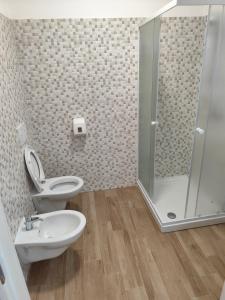 a bathroom with a shower and a toilet and a sink at La Locanda del Voltigno in Villa Celiera +18 photos