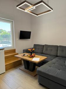 a living room with a couch and a table at Holiday Home Korda in Čapljina