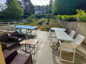 a patio with a table and chairs and a table and chairsktop at Maison familiale Cherbourg-ping pong-baby foot in Cherbourg en Cotentin