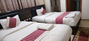 Llit o llits en una habitació de Hotel Simara