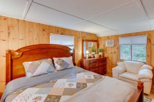 a bedroom with a bed and a chair at Rustic Berkshires Cottage at Lake Buel with Kayaks! in New Marlborough